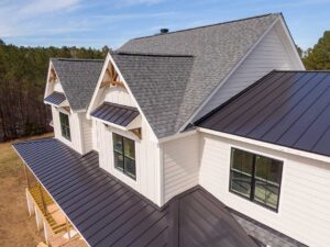 A worker installs metal flashing around a residential chimney on an asphalt shingle roof.
