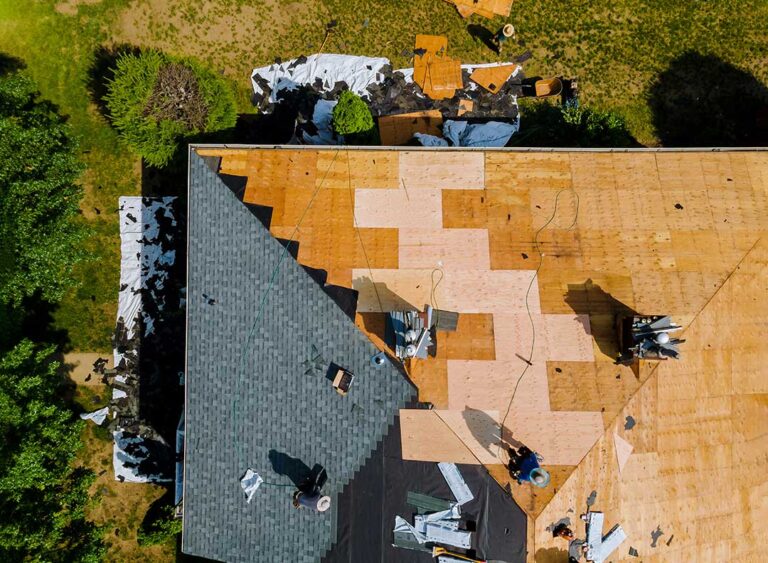 Plastic bins of holiday decorations stored safely away from attic vents and roof framing